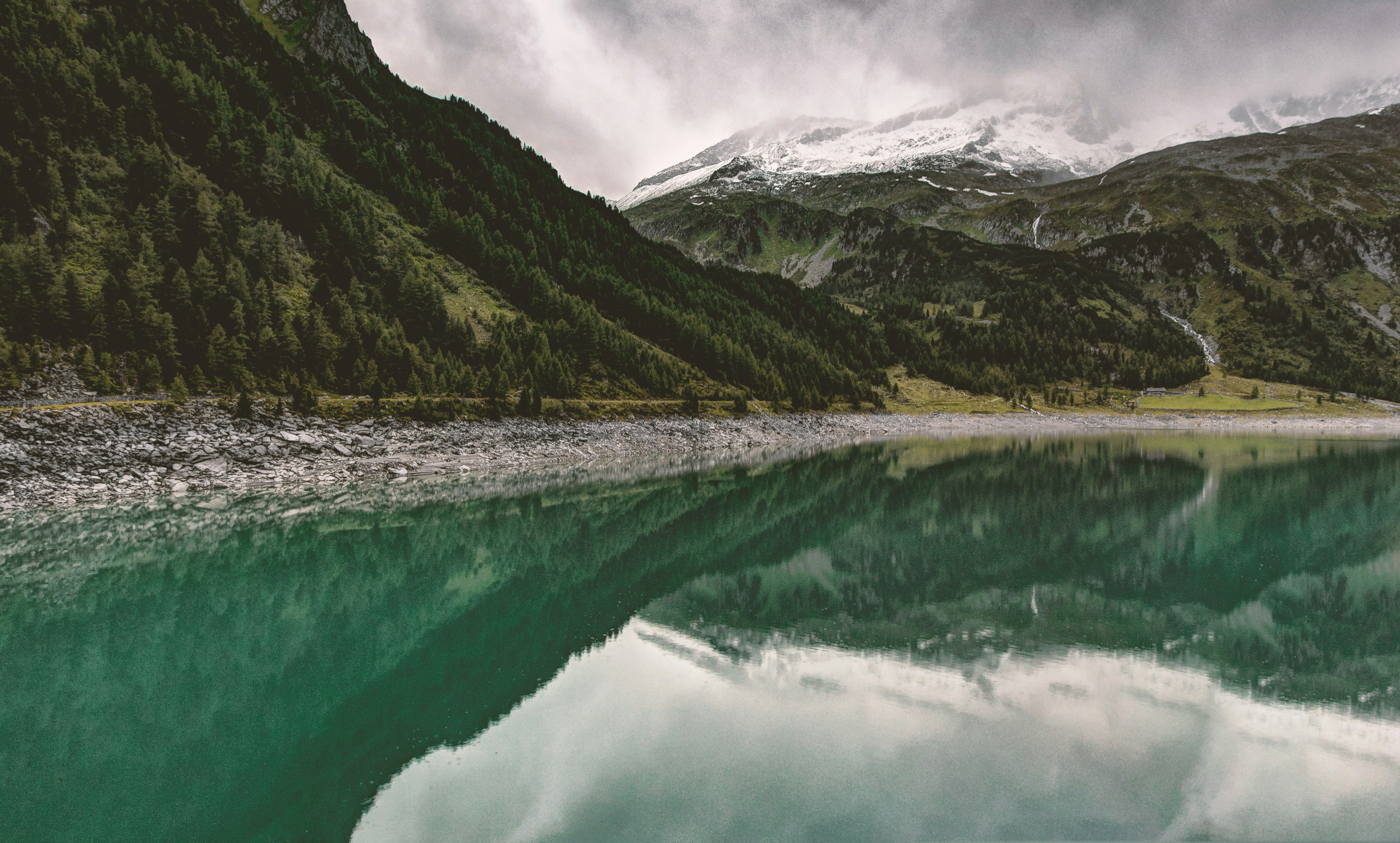 green mountains near body of water